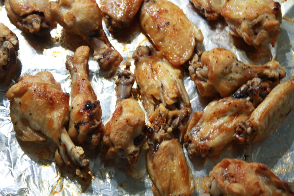 Chicken wings on a baking sheet.