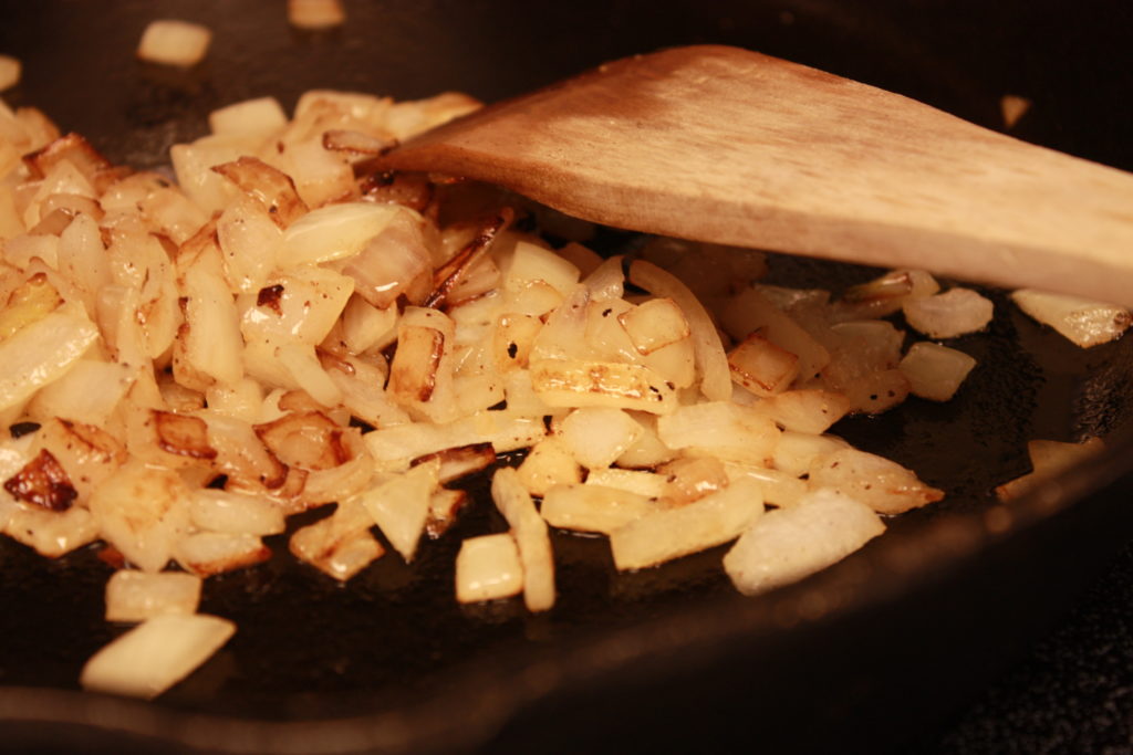 Sauted onions in a skillet.