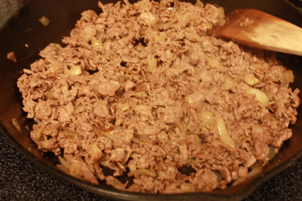 Philly cheesesteak meat ready to add the cheese whiz.