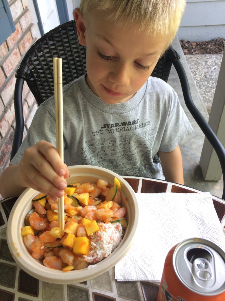 Landon and his to go poke bowl from the local place - shrimp, crab & mango madness