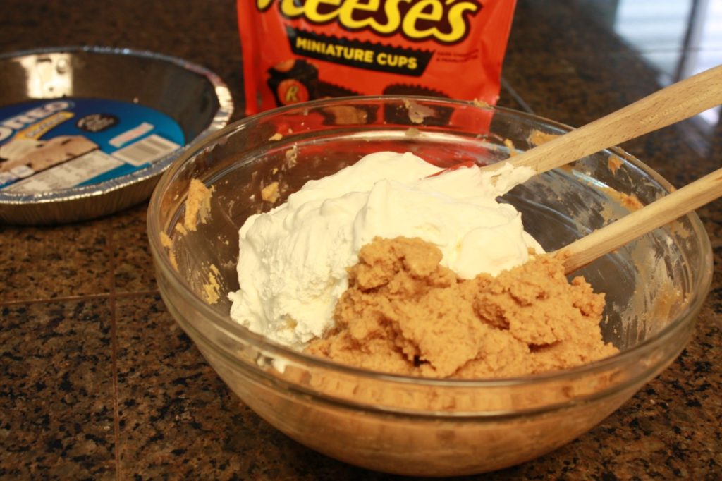 Folding in the cool whip topping with the peanut butter mixture.