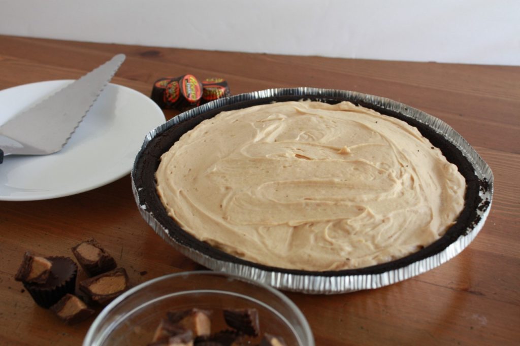 Frozen Peanut Butter Cup Pie in an Oreo cookie crust frozen and ready to cut.