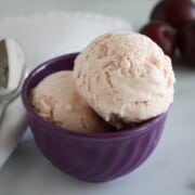 Plum Ice Cream in a bowl with spoon on the side