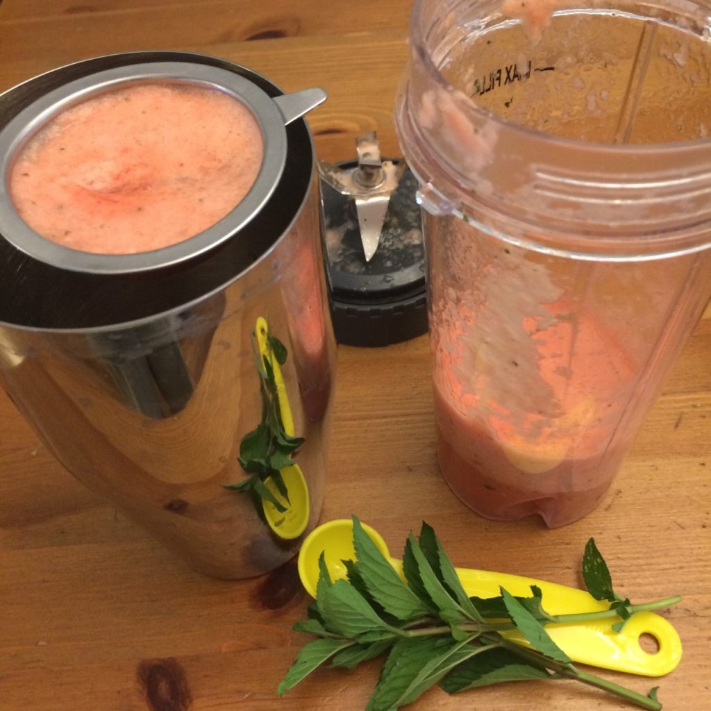 Watermelon puree being strained over a cocktail shaker.