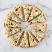 Christmas Cream Cheese Chocolate Cookie Bars cut into wedges and displayed like a wreath