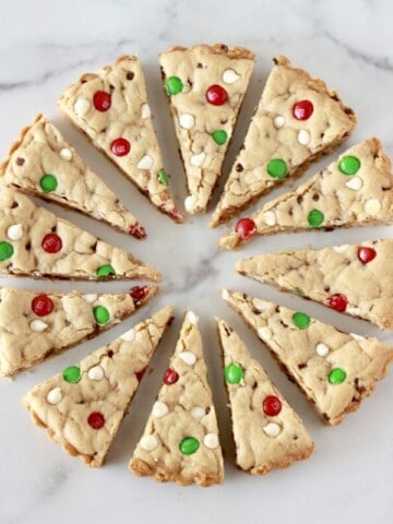 Christmas Cream Cheese Chocolate Cookie Bars cut into wedges and displayed like a wreath