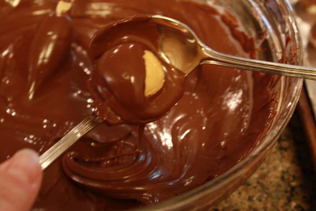 Dipping peanut butter balls in chocolate