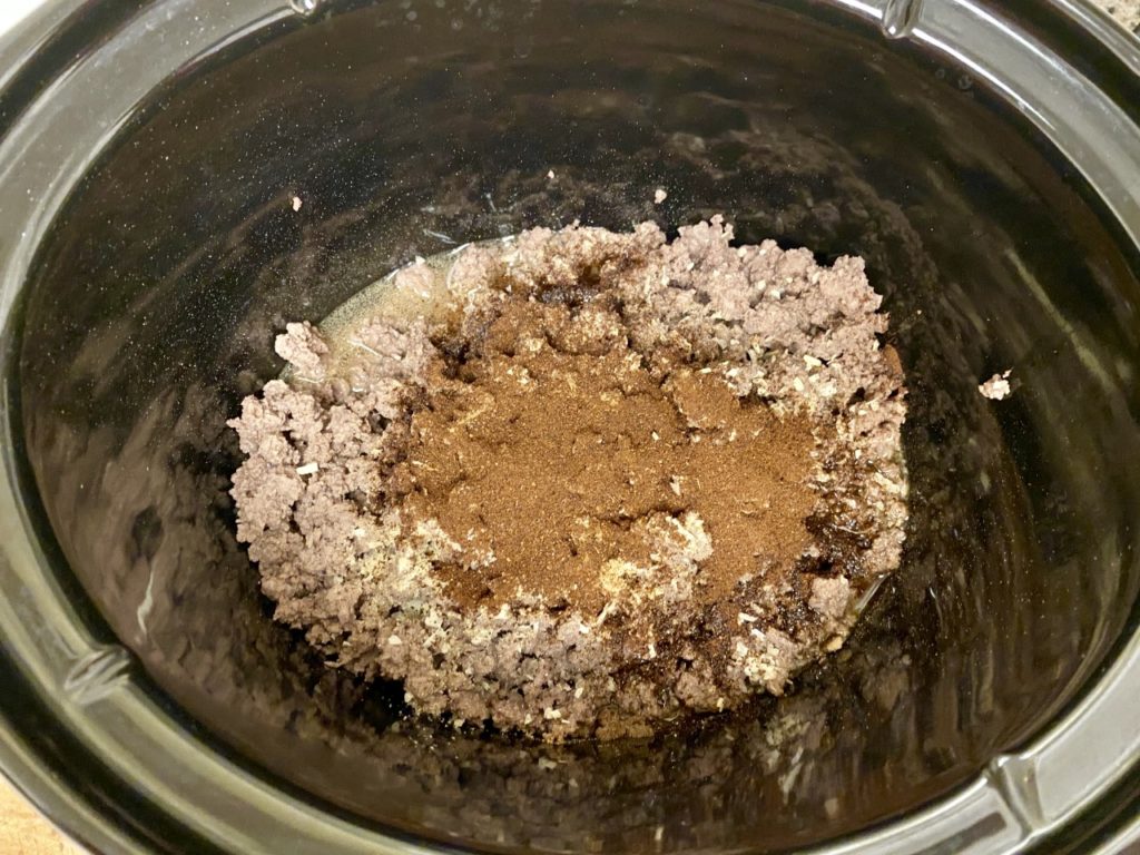 Ground beef and chili spices added to CrockPot insert