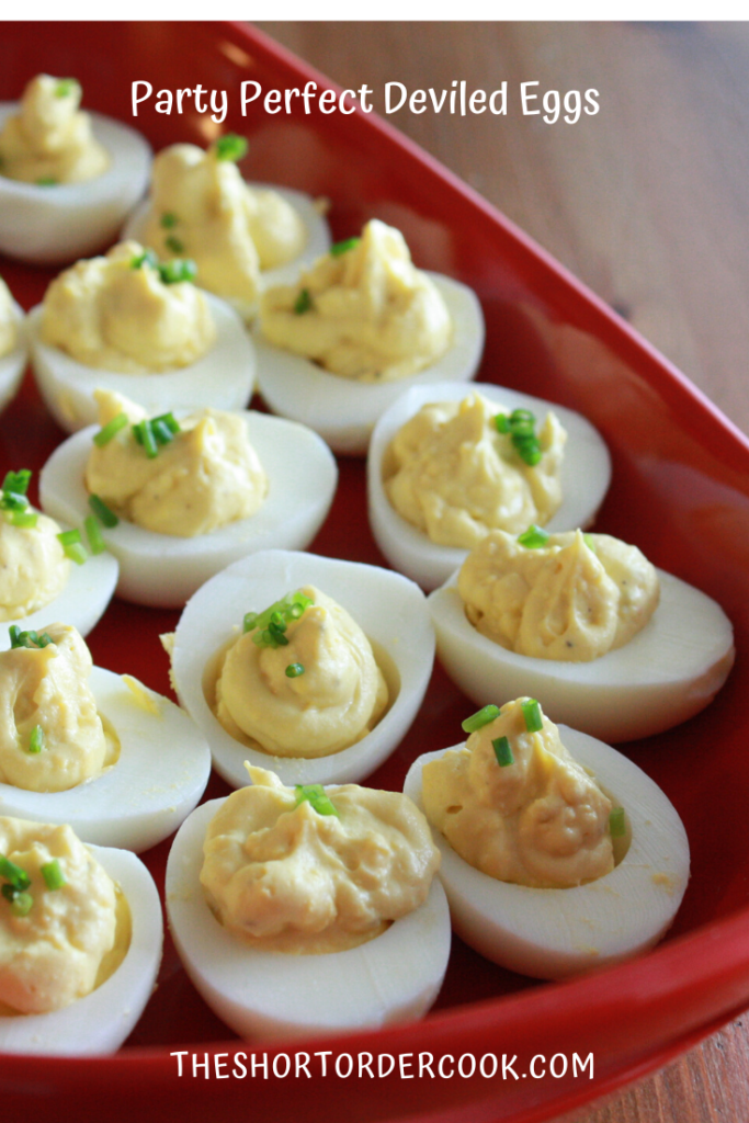 Red platter with dill pickle deviled eggs.