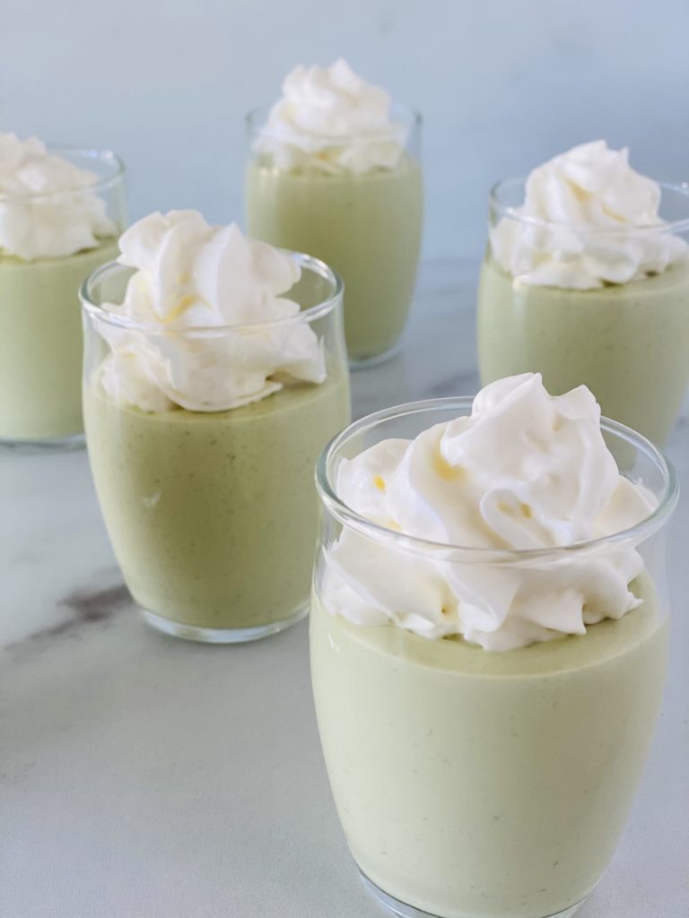 St Patricks' Day Pudding Shots topped with whipped cream.