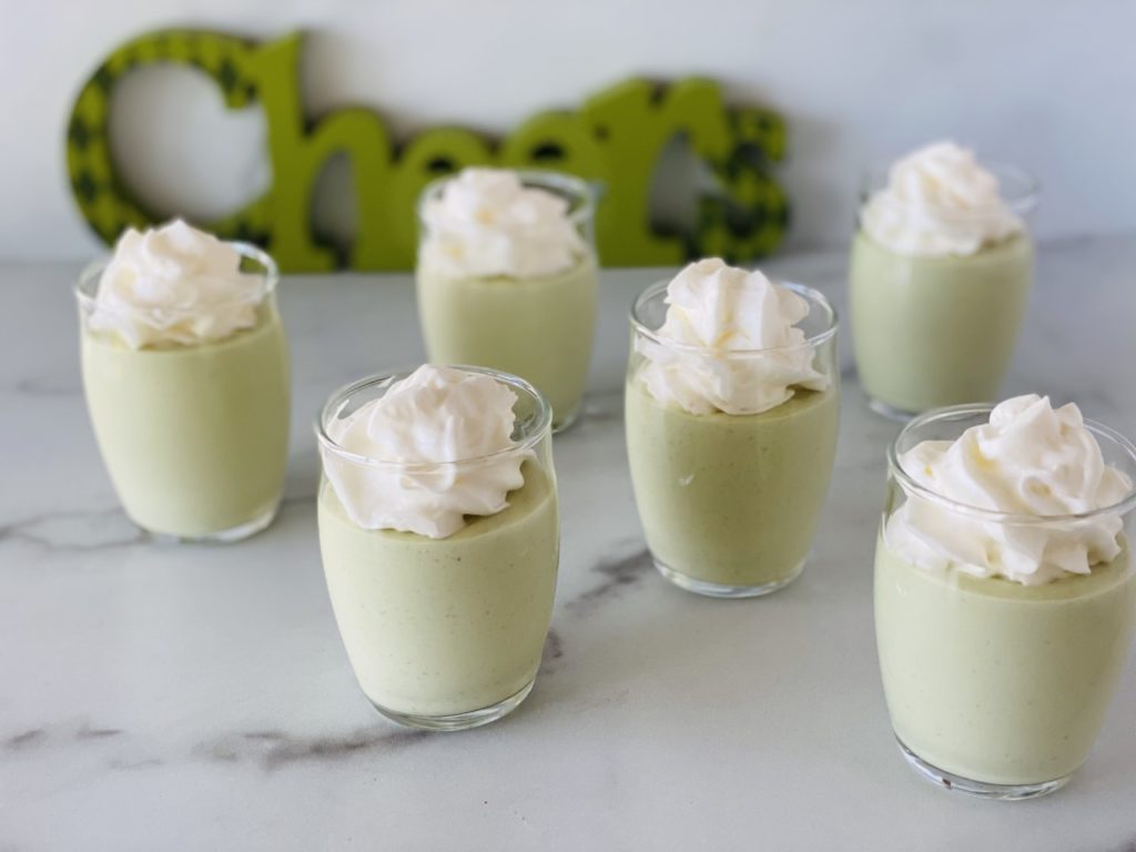 St Patricks' Day Pudding Shots in small glasses topped with whipped cream.