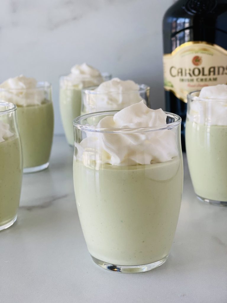 St Patricks' Day Pudding Shots in small glasses topped with whipped cream.