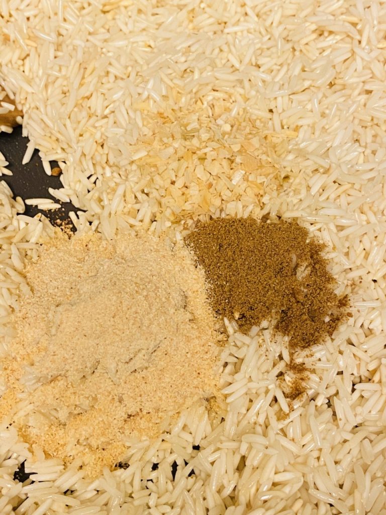 Rice and spices toasting in the pot. 