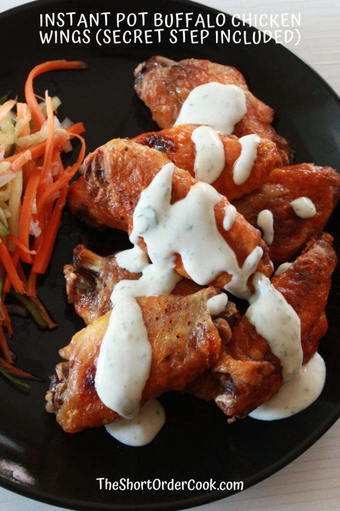 Plated Instant Pot chicken wings with buffalo sauce and homemade ranch.