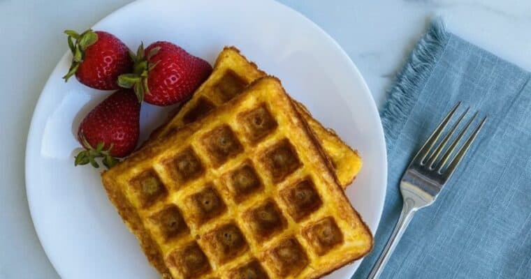 Keto Belgian Chaffles plated with strawberries.