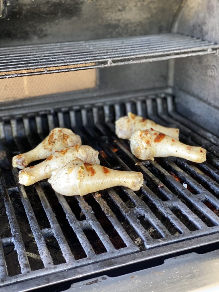 drumsticks cooking on the grill
