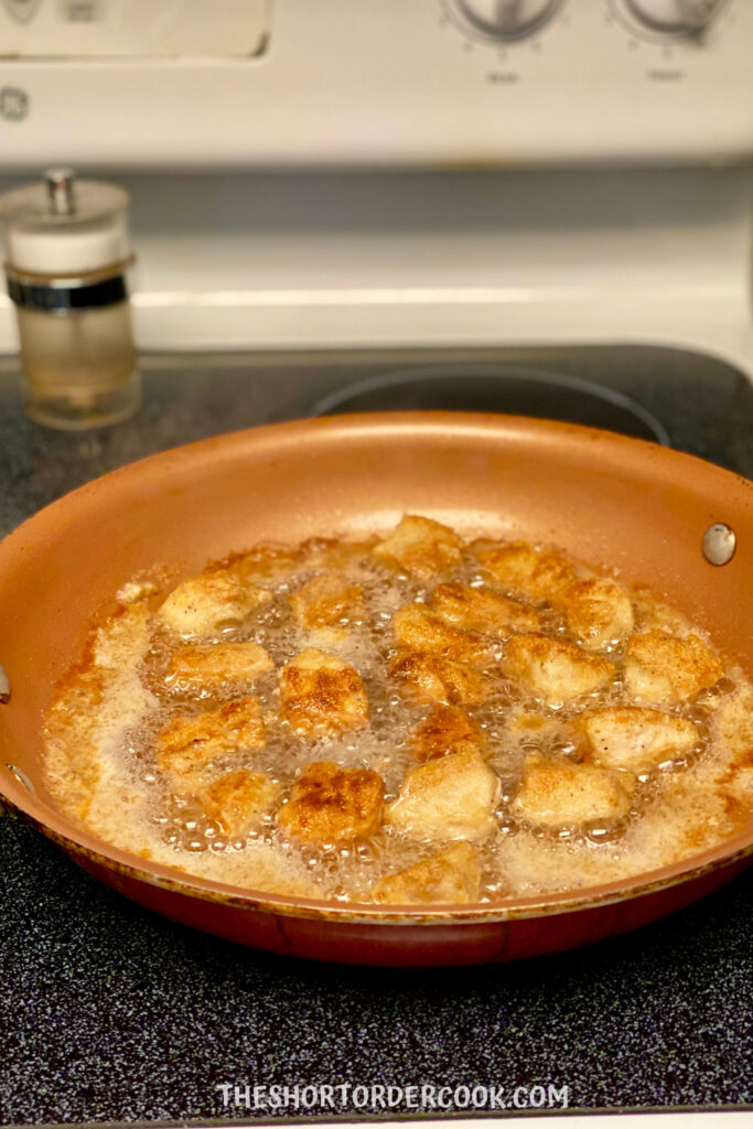 Grain Free Fried Keto Chicken Nuggets golden brown in a skillet.