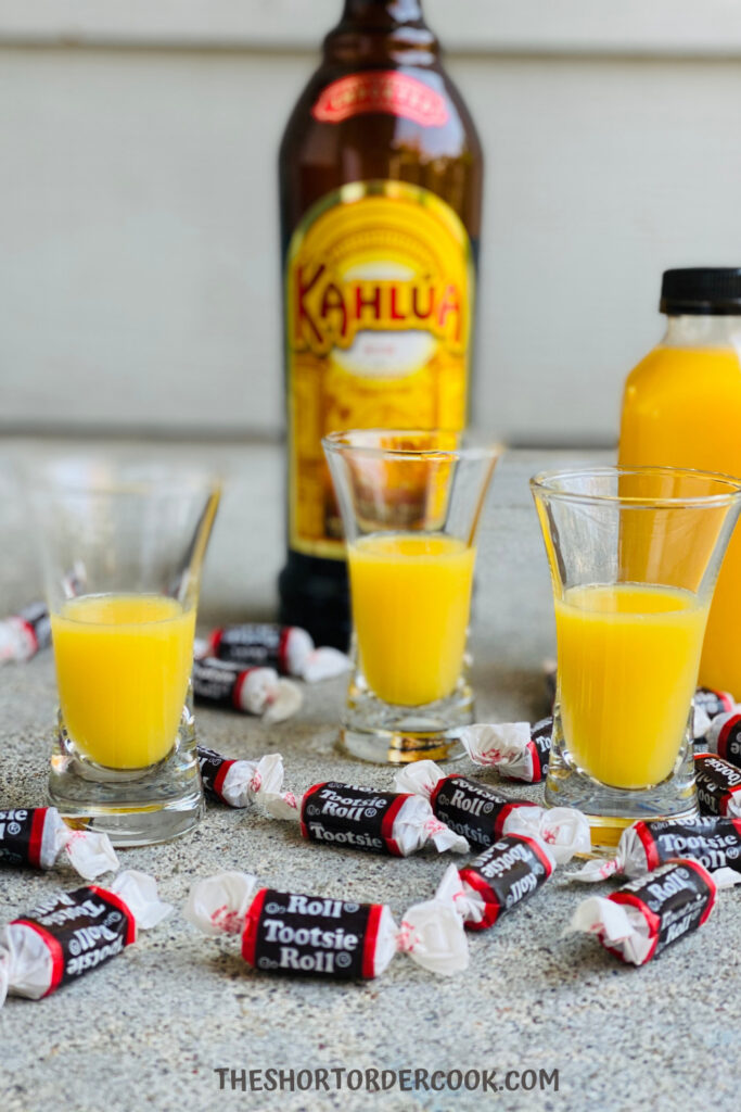 Fill shot glasses with orange juice