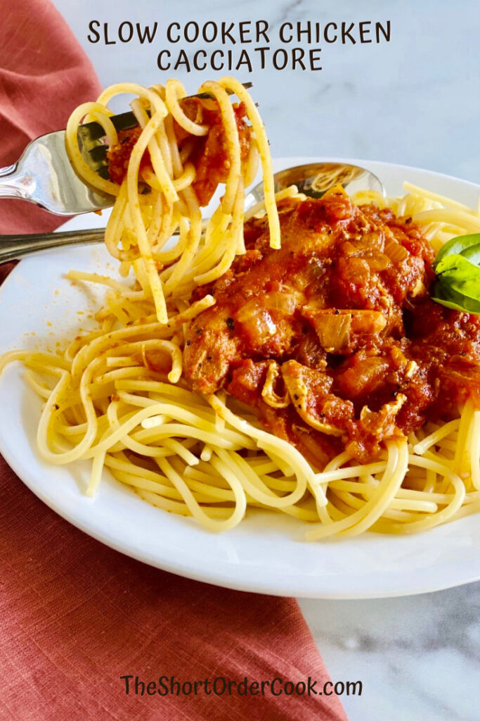 Slow Cooker Chicken Cacciatore plated on top of cooked spaghetti.