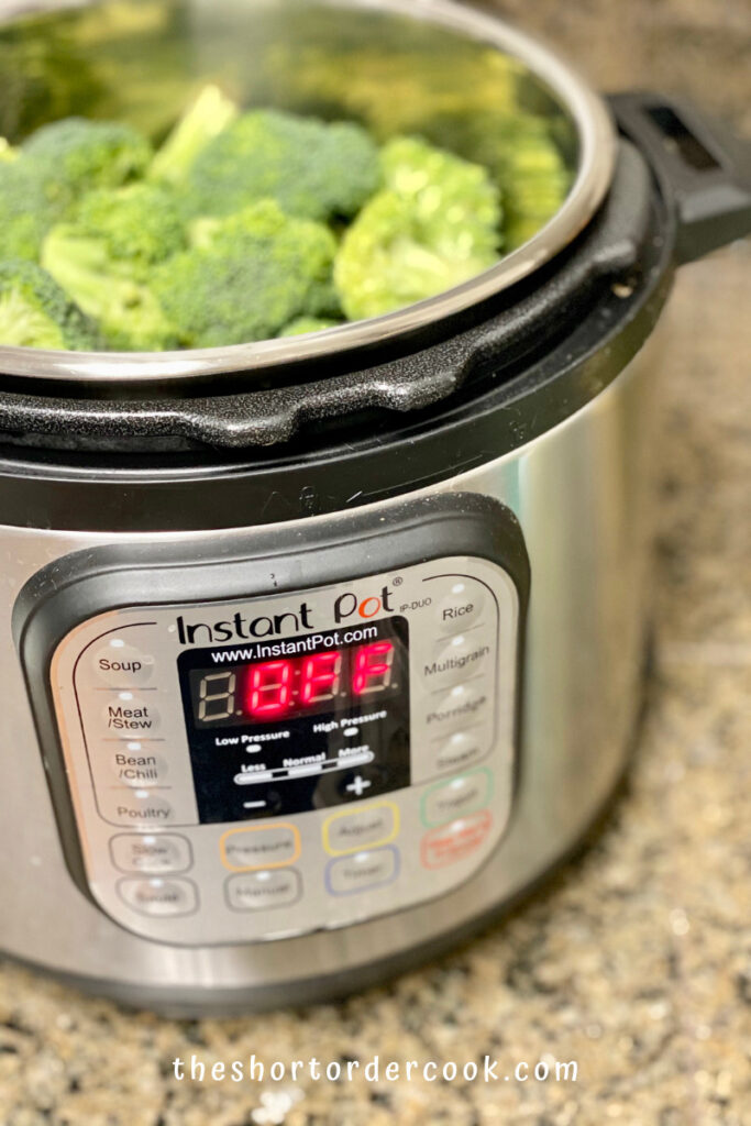 Instant Pot Steamed Broccoli steamer and broccoli in the insert