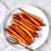 plate with maple glazed carrots and a large serving fork