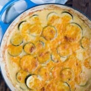 Baking dish with zucchini gratin covered in cheese