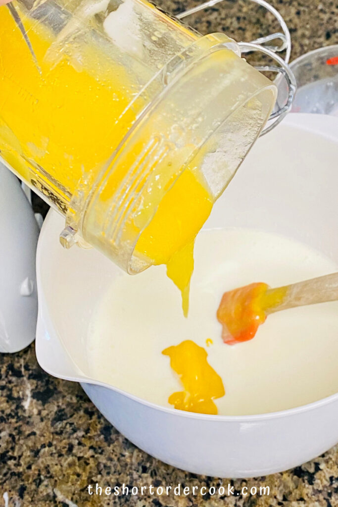 Best Ever Mango Ice Cream pour puree into cream and sugar