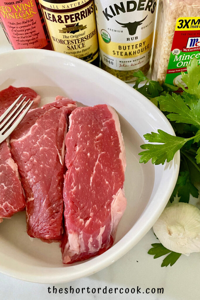Keto Steak Marinade ingredients on a table with steak in a dish ready to marinde