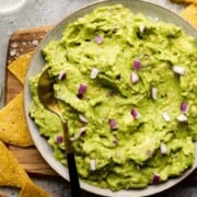 What to Serve with Fajitas Guacamole-blog-6 biteswithbri big bowl of guacamole with chips around it