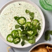 What to Serve with Fajitas Jalapeno-Greek-Yogurt-Dip-Close-Up cupofzest a bowl of dip topped with sliced jalapenos