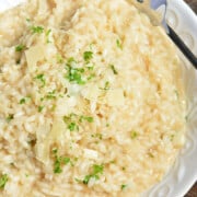 What to Serve with Lobster Parmesan-Risotto-5-1 willcookforsmiles a large bowl of cooked parmesan risotto with a sprinkling of parsley