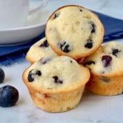Old-Fashioned Mini Blueberry Muffins featured stack of muffins