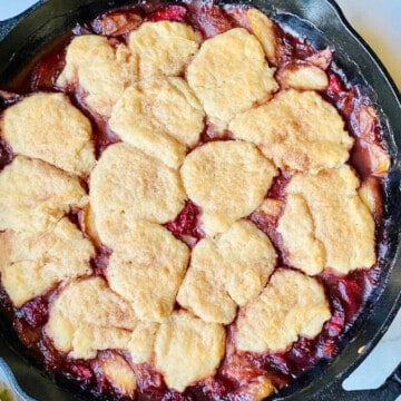 Old-Fashioned Skillet Peach & Strawberry Cobbler featured overhead of skillet for recipe card