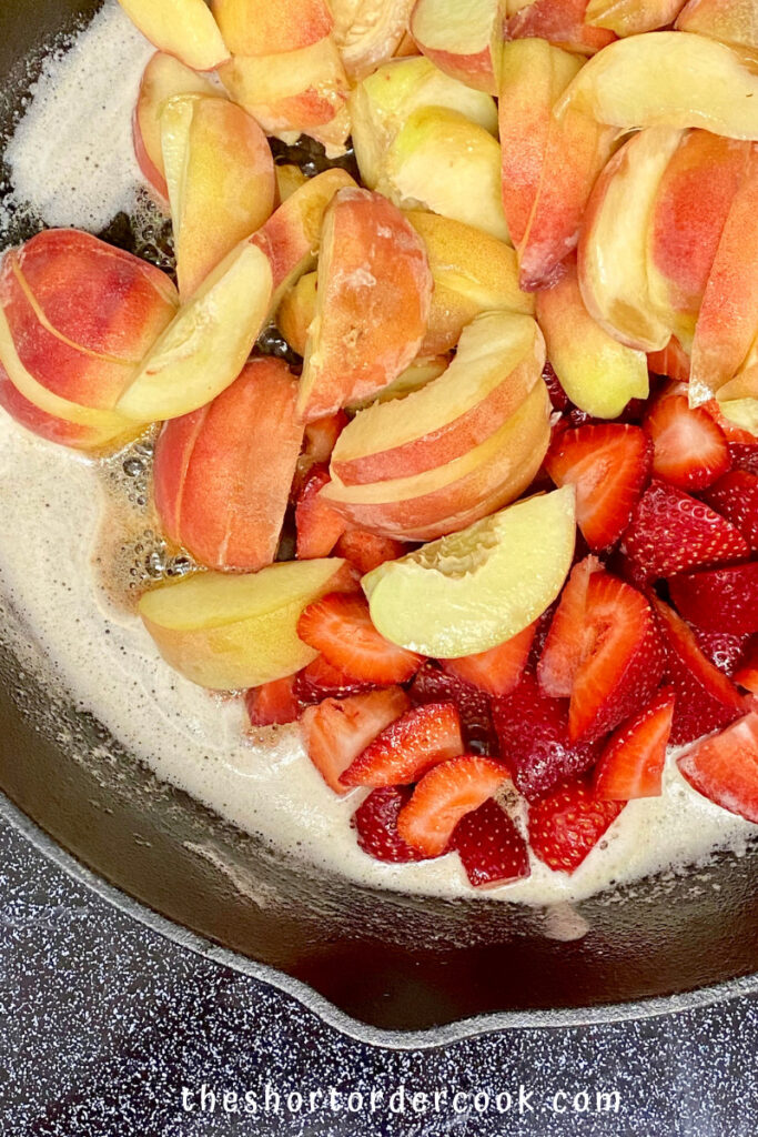 Old-Fashioned Skillet Peach & Strawberry Cobbler fruit in the cast iron skillet