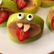 Vegan Halloween Treats & Drinks silly apples apl4-563x750 sulaandspice apple slices with peanut butter between them and googly eyes on the top slice