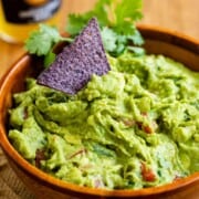 What to Serve with Quesadillas Alton-Brown-Guacamole-Recipe thecozycook a close up of a bowl full of bright green quacamole