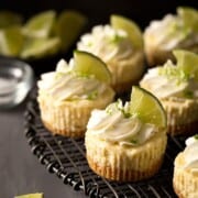 What to Serve with Quesadillas Mini-Margarita-Cheesecakes-0572 chocolatemoosey a tray with 6 mini cheescakes topped with cream and a lime wedge