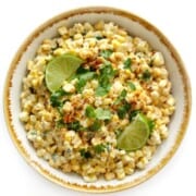 What to Serve with Quesadillas Vegan-Mexican-Street-Corn-Salad-5 strengthandsunshine a white table with an overhead photo of a serving bowl full of corn salad