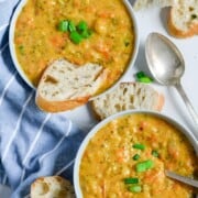 What to Serve with Sandwiches instant-pot-broccoli-cheddar-soup-six cookedbyjulie two bowls filled with chunky broccoli cheese soup with wedges of bread and spoons