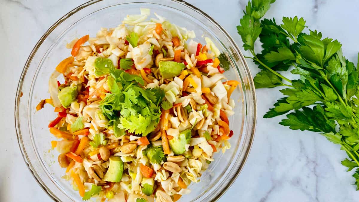 Asian Avocado Peanut Coleslaw featured closeup bowl and parsley but no serving utensils recipe card