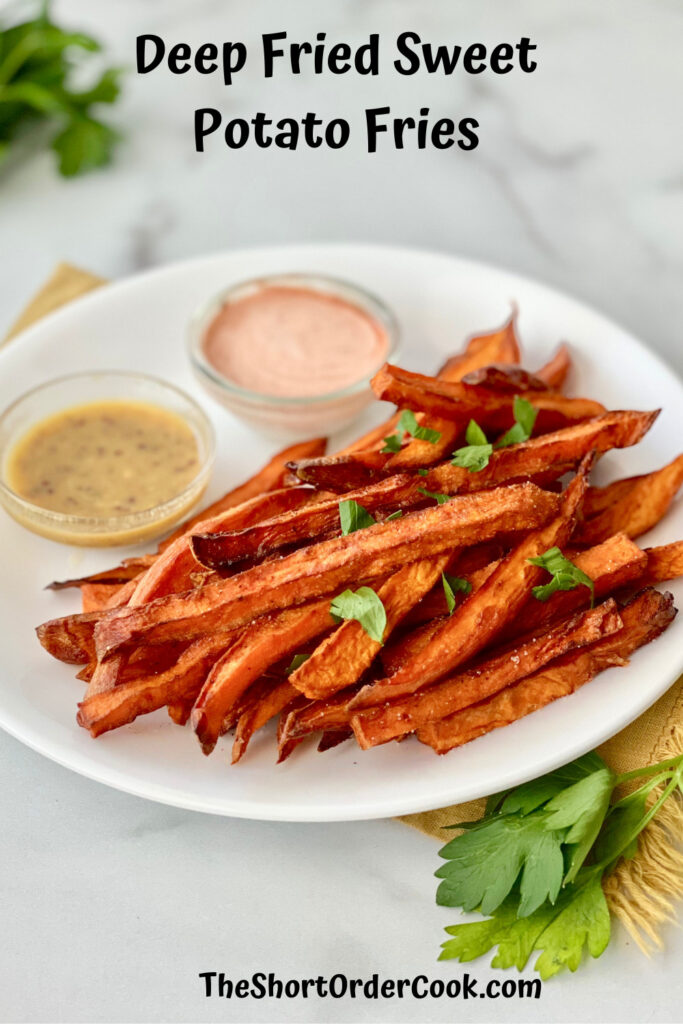 Deep Fried Sweet Potato Fries PN1 a plate of fries with two dipping sauces and parsley sprinkled on top