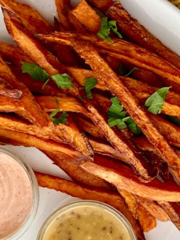 Deep Fried Sweet Potato Fries featured close up with dipping sauces on the bottom
