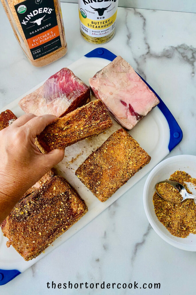 Smoked Beef Short Ribs applying the rub to the meat