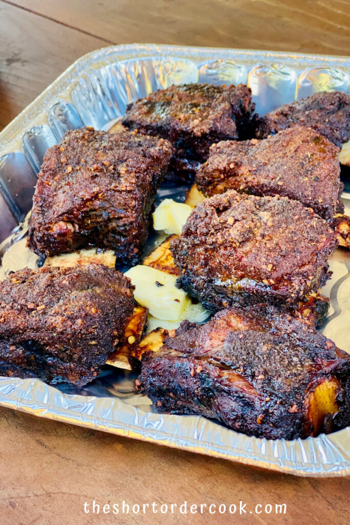 Smoked Beef Short Ribs ribs in the foil tray with butter