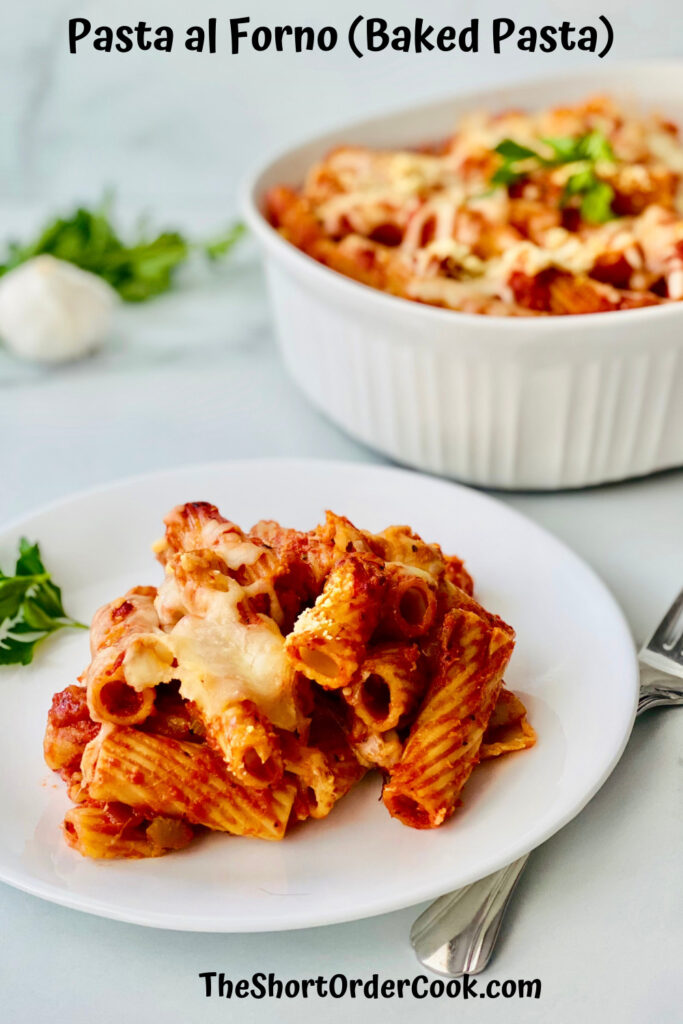 Rigatoni al Forno (Baked Pasta) on a plate and the casserole dish in the background.