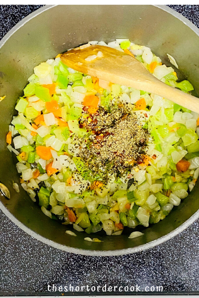 Cooked vegetables in the pot with the spices added to the top.