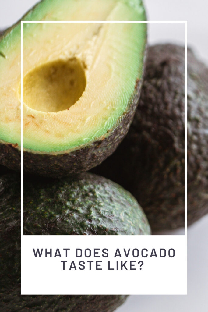 What Does Avocado Taste Like? PINREDO upclose of an avocado cut to reveal the light green flesh and pit is removed