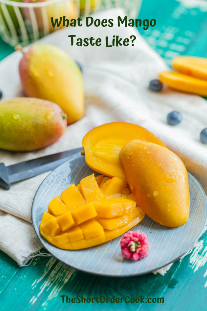 What Does Mango Taste Like PN1 a plate with a mango cut open to eat and other mangos in the background