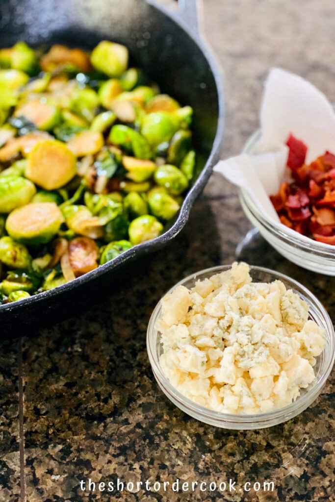 Caramelized Brussel Sprouts with Brown Sugar, Bacon, & Blue Cheese ready to eat with blue cheese and bacon in small bowls