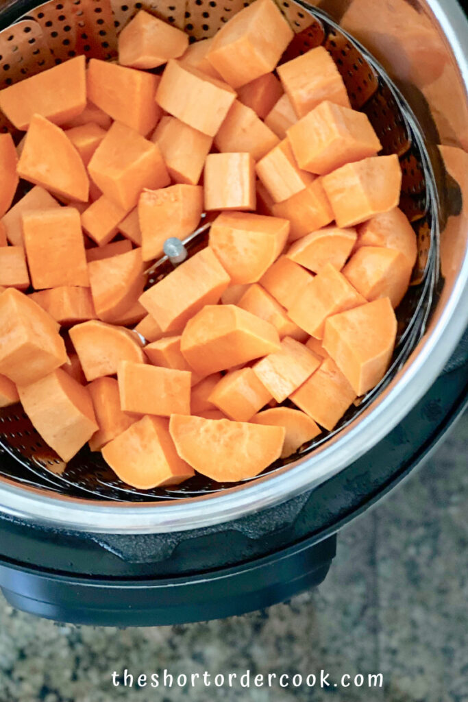 Instant Pot Cubed Sweet Potatoes raw on the steamer insert in the pressure cooker